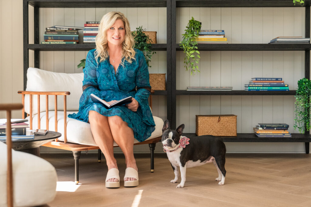 CutiePaws owner reading with French Bulldog wearing floral collar, showcasing a peaceful pet care moment