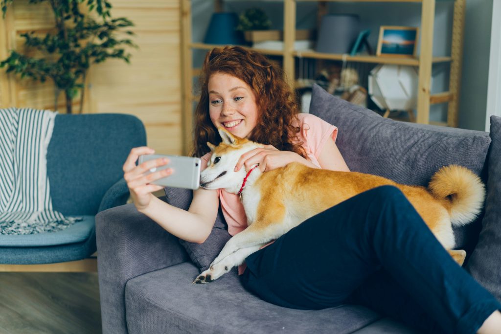 Atlanta pet sitter sharing photo updates with a dog during an in-home pet sitting visit