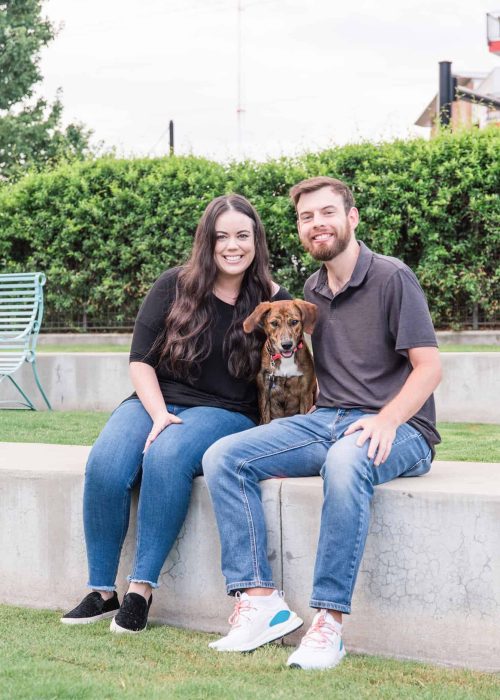 Pet sitting team with a dog in a park setting.